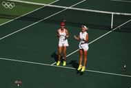 RIO DE JANEIRO, BRAZIL - AUGUST 14:  Elena Vesnina and Ekaterina Makarova of Russia celebrate victory in the women's doubles gold medal match against Martina Hingis and Timea Bacsinszky of Switzerland on Day 9 of the Rio 2016 Olympic Games at the Olympic Tennis Centre on August 14, 2016 in Rio de Janeiro, Brazil.  (Photo by Clive Brunskill/Getty Images)